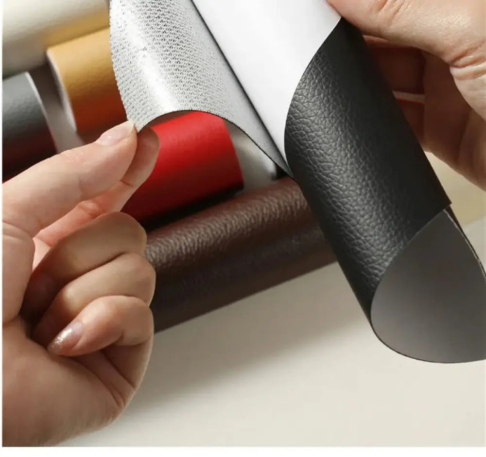 Black self adhesive pebbled leather repair patch roll showing black textured faux leather with silver metallic backing