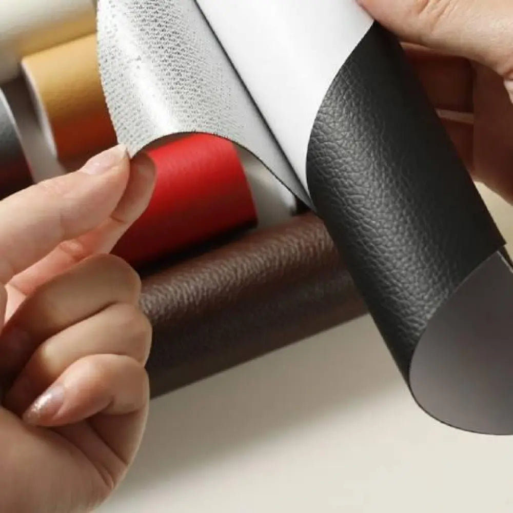 Black self adhesive pebbled leather repair patch roll showing black textured faux leather with silver metallic back