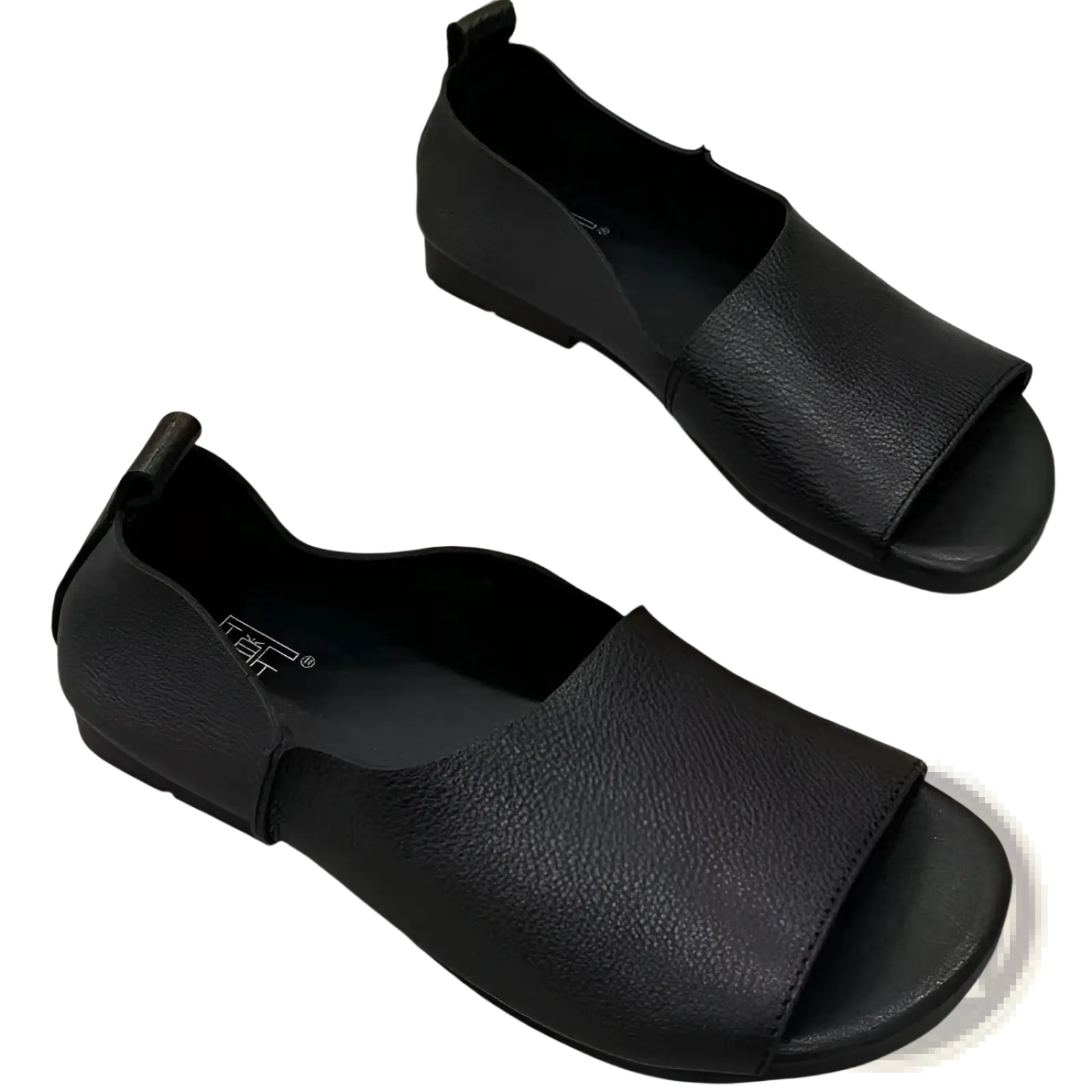 Black leather sandals with textured soft sole, peep toe, slip-on design, low heel, and elastic side strap
