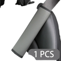 Gray leather seat belt cover with black stitched edges showing textured fabric back side for vehicle use