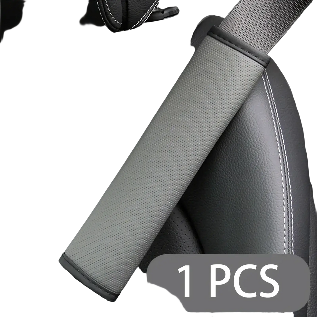 Gray leather seat belt cover with black stitched edges showing textured fabric back side for vehicle use
