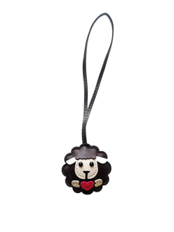 Leather sheep keychain made of black leather with white face, red heart, and gold accents as a cute animal bag charm