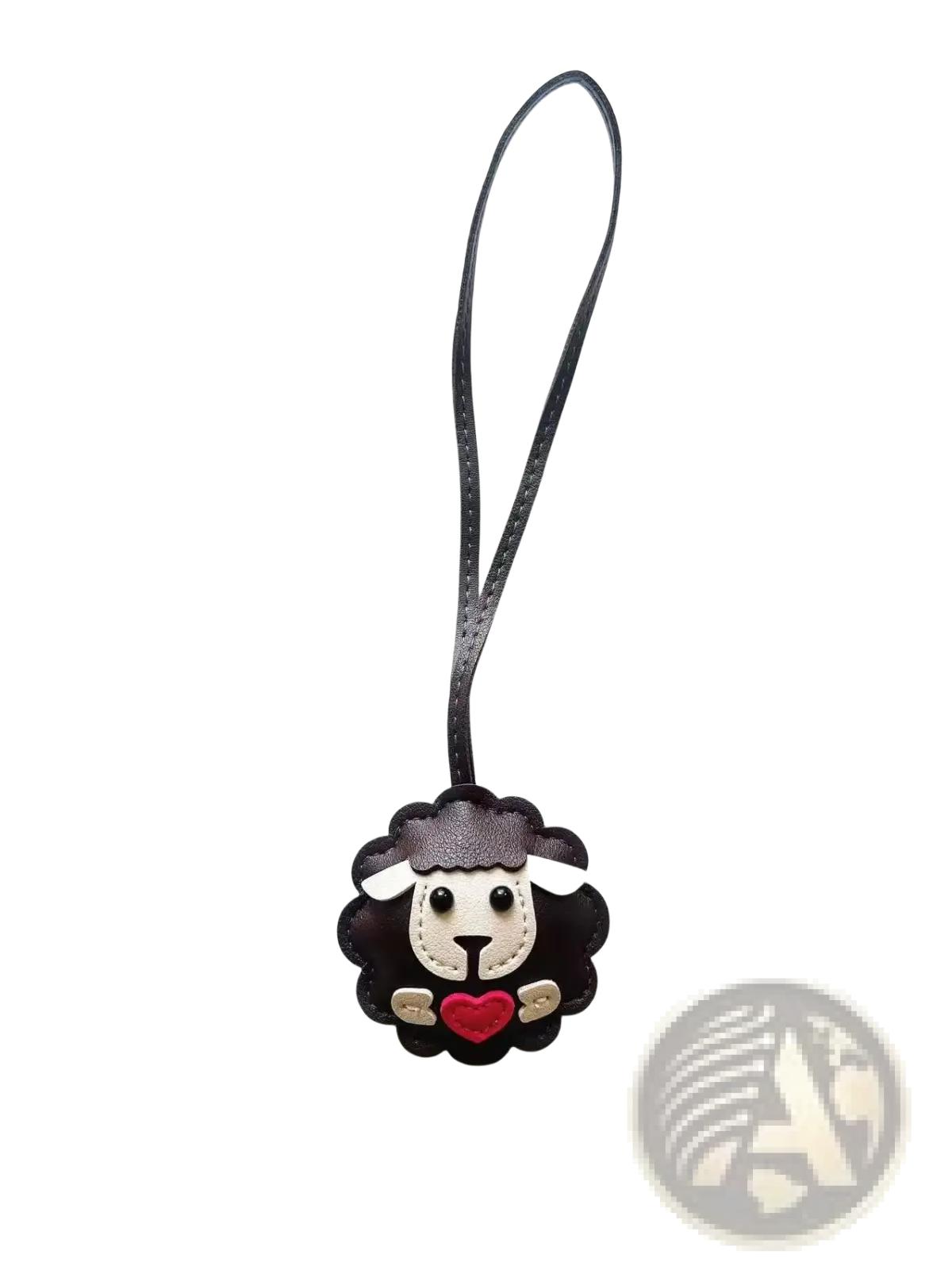 Leather sheep keychain made of black leather with white face, red heart, and gold accents as a cute animal bag charm