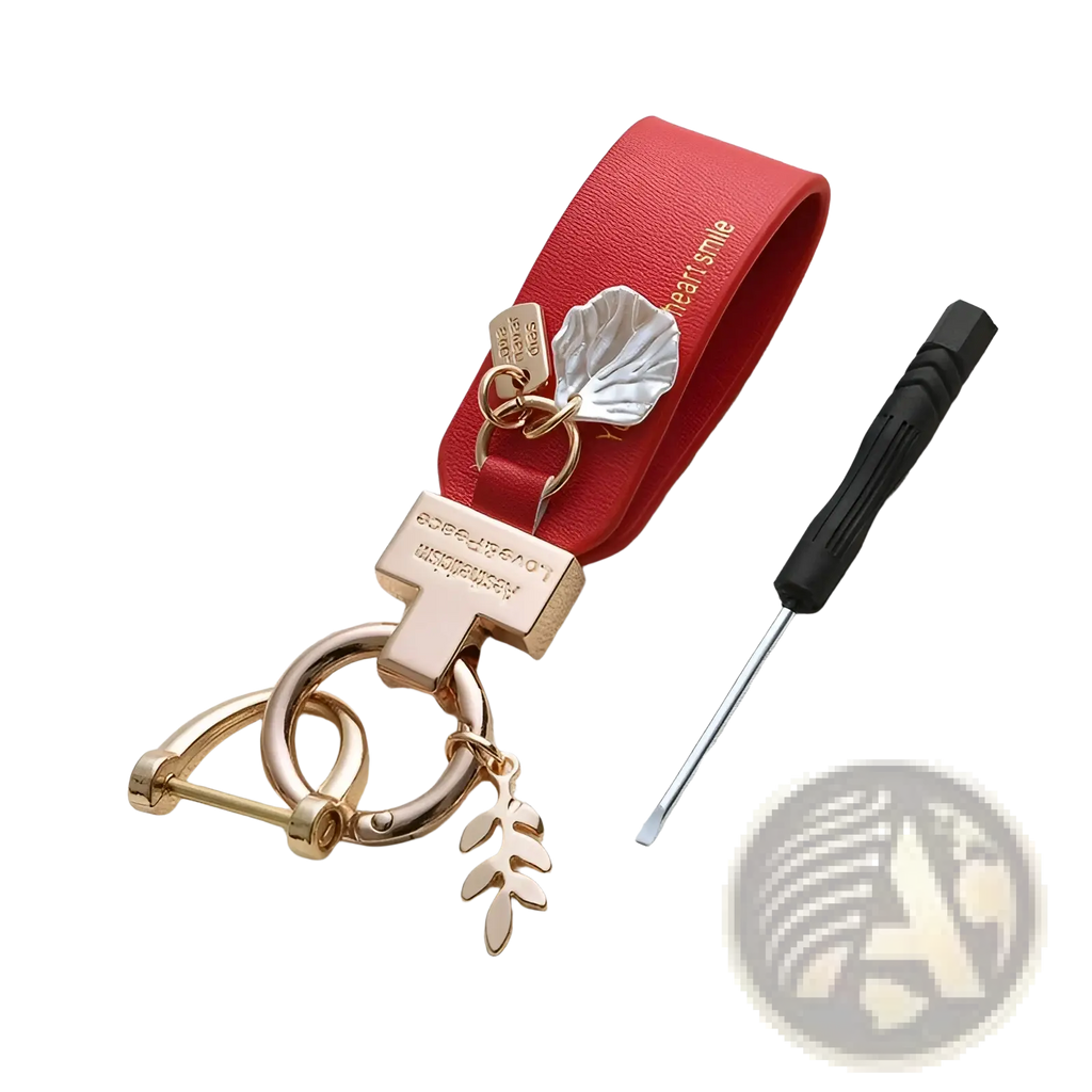 Red leather shell keychain with rose gold metal accents and leaf charms designed as a French style anti loss car charm