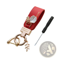 Red leather shell keychain with rose gold metal accents and leaf charms designed as a French style anti loss car charm