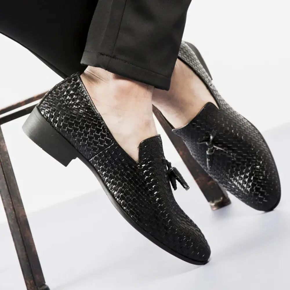 Men’s black woven leather loafers featuring tassel detail for formal and casual wear
