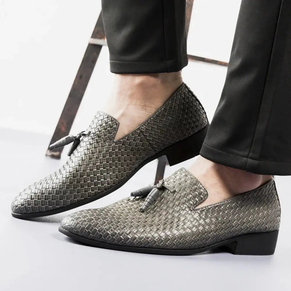 Men’s black woven leather tassel loafers shown in silver color with detailed weaving and tassel accents