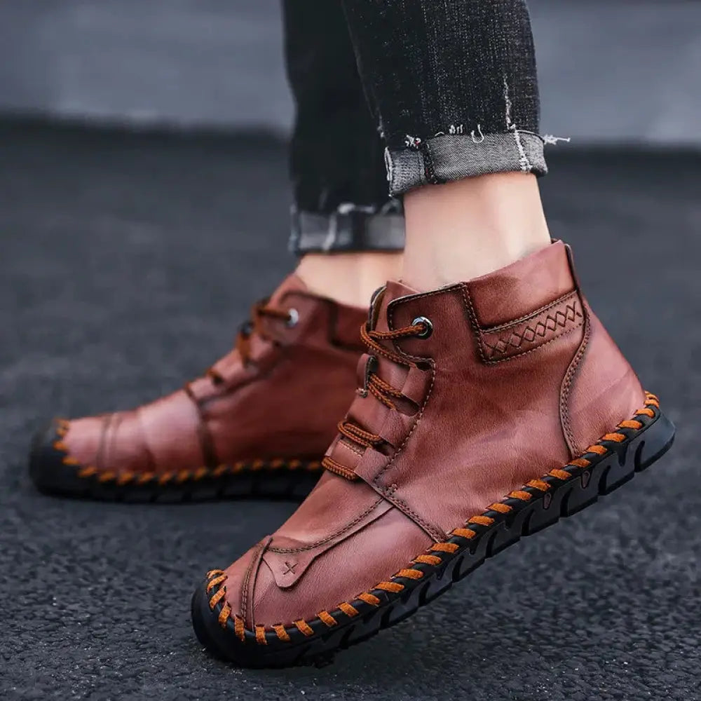 Arbaglobal men’s handcrafted brown leather ankle boots with orange stitching and rugged black sole for casual wear