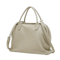 A soft beige leather shoulder bag with textured cowhide surface, dual handles, and adjustable strap from Guangdong province