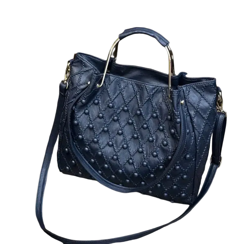 Black quilted leather shoulder bag showing gold-tone handles and pocket interior with studs detailing