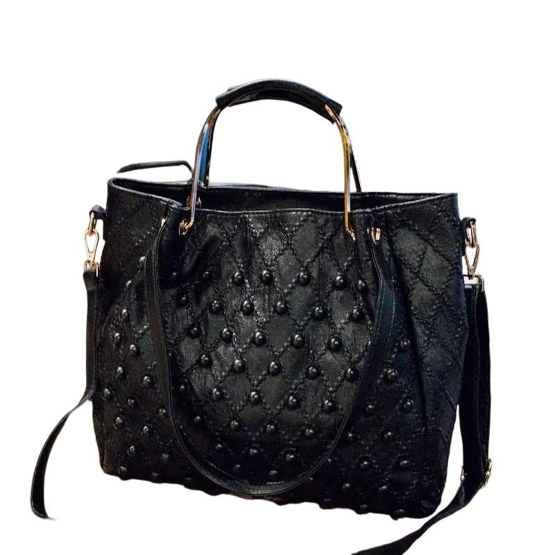 Black studded quilted leather shoulder bag with gold-tone hardware and pocket interior visible through top handle view