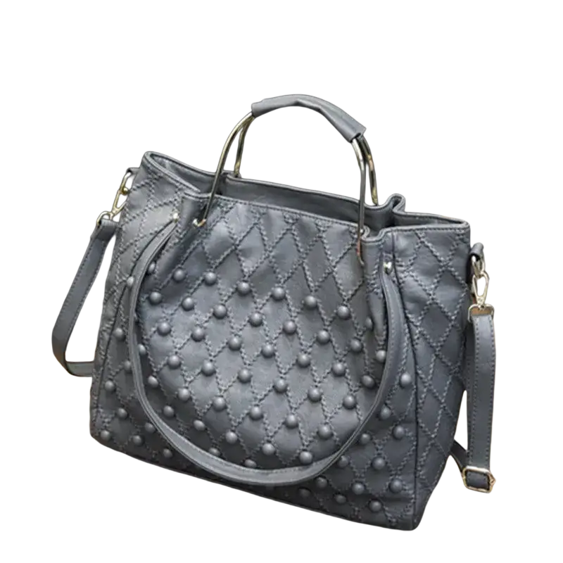 Gray leather quilted shoulder bag with silver hardware and decorative studs showing pocket interior details