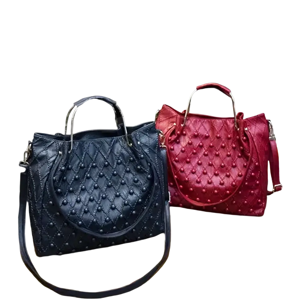 Navy blue quilted leather shoulder bag with metallic studs gold-tone handles and spacious pocket interior detail