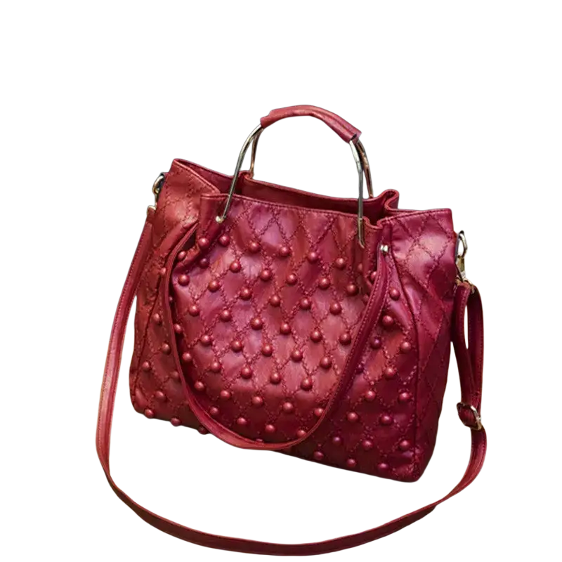 Red leather shoulder bag with quilted design, pearl-like studs, gold-tone handles, and pocket interior detail