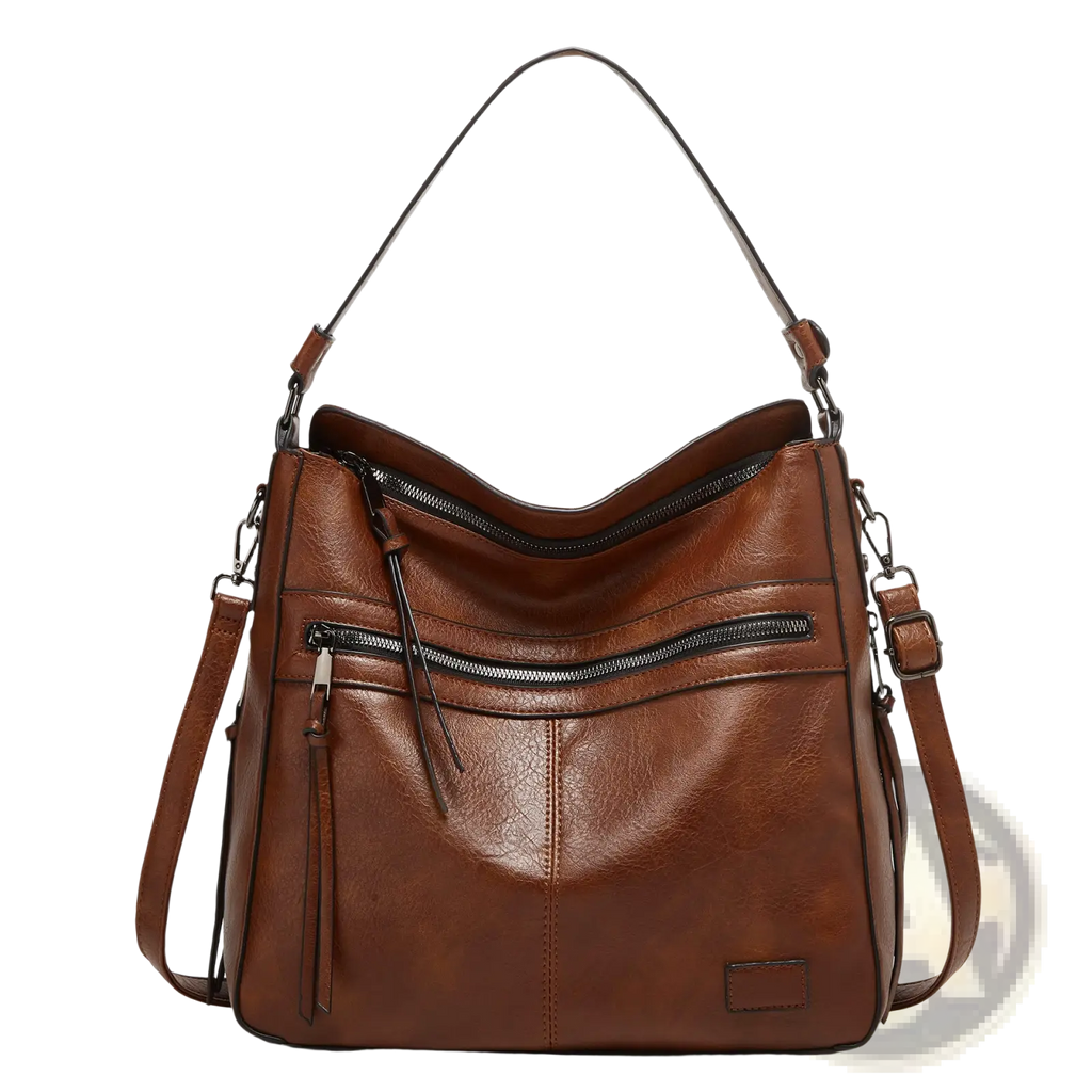 Brown leather shoulder bag with black zippers and adjustable straps designed as a multi zipper crossbody tote