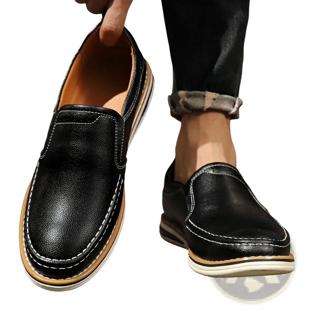 Black leather slip on loafer with white stitching and tan and white rubber sole for casual wear