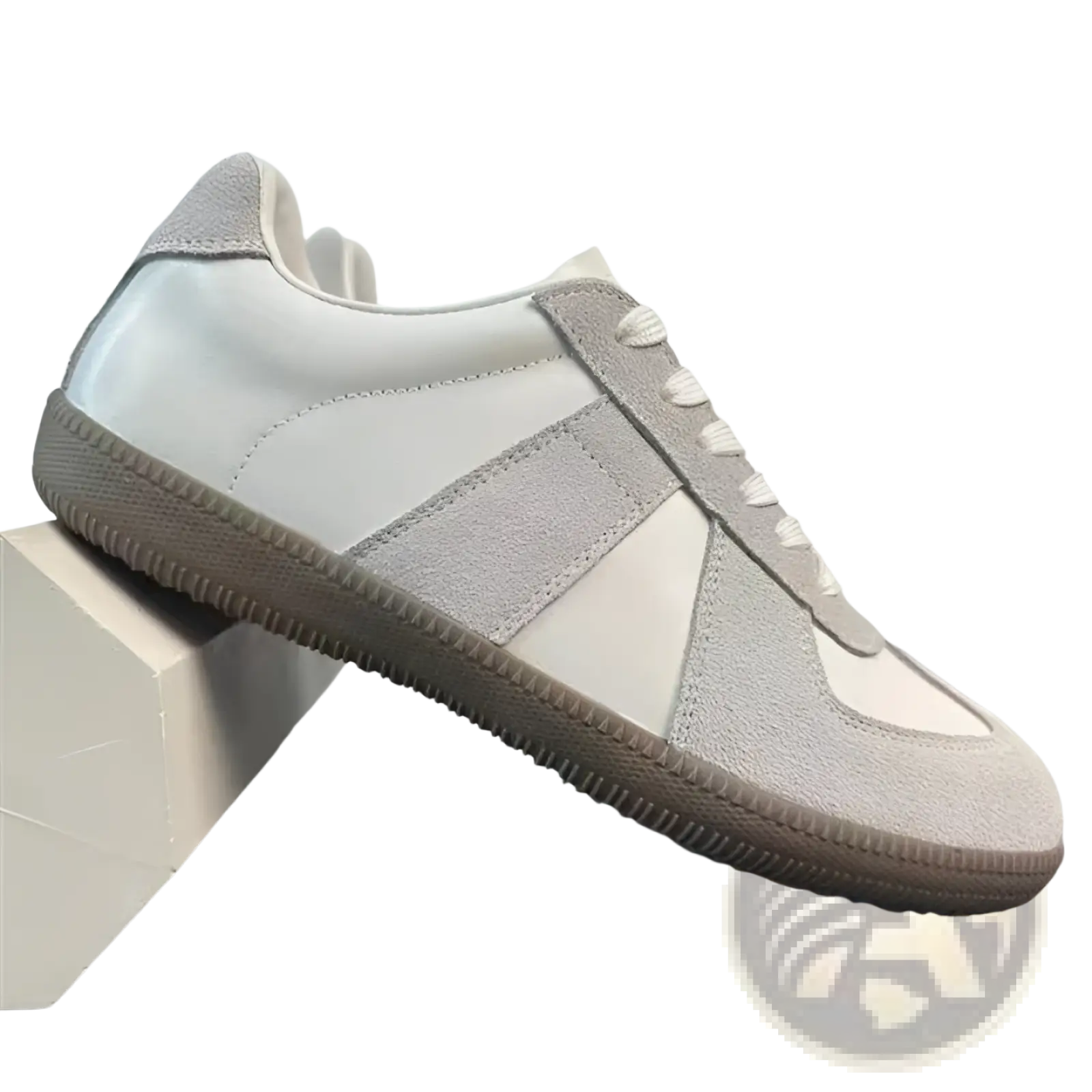 A minimalist gray and white leather sneakers with suede upper and chunky sole for versatile casual wear