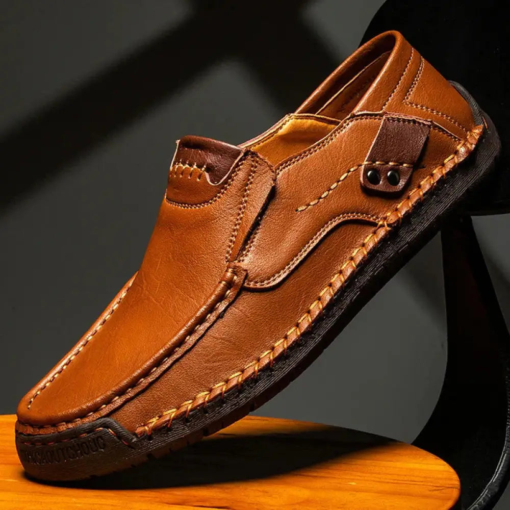 Men’s premium soft sole leather business loafers in tan with visible stitching and dark brown rubber sole slip-on design