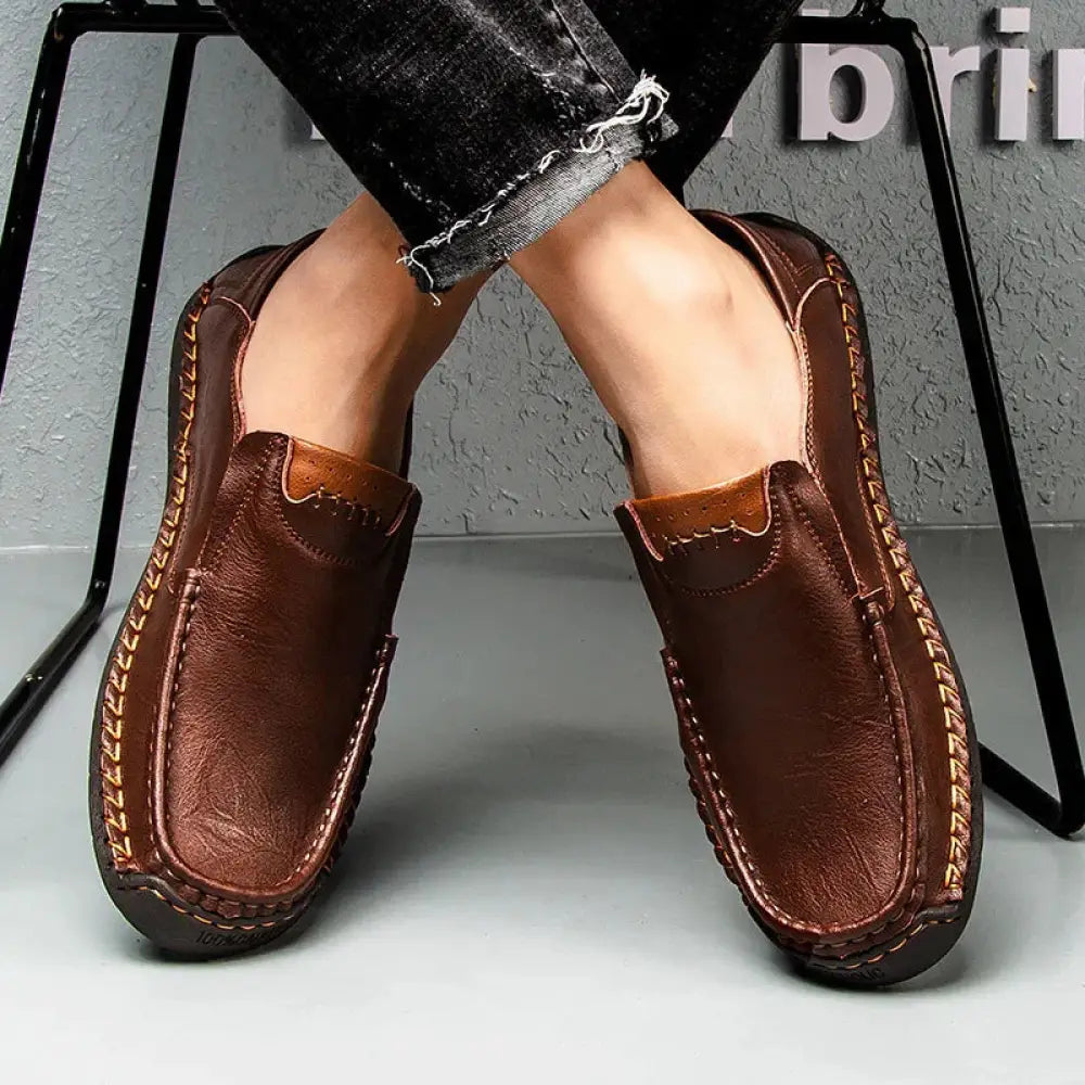 Men’s premium soft sole leather business loafers in brown with visible side stitching and lighter brown vamp accent