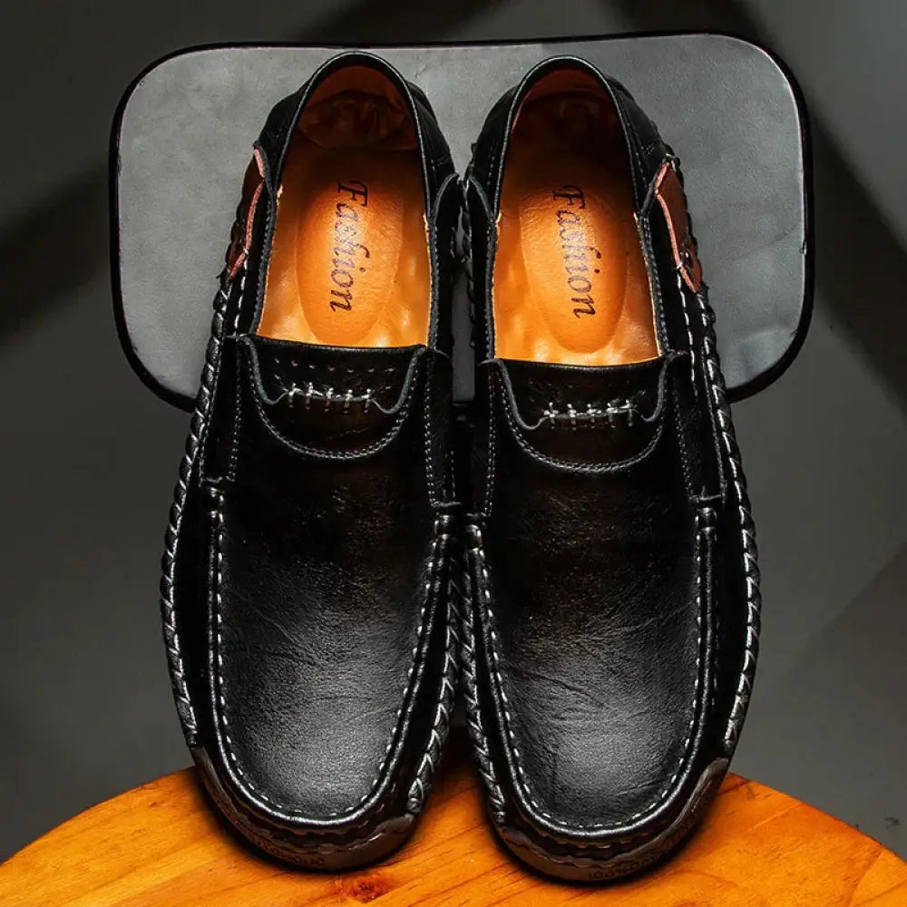 Men’s premium soft sole black leather loafers with white stitching and braided design for business wear