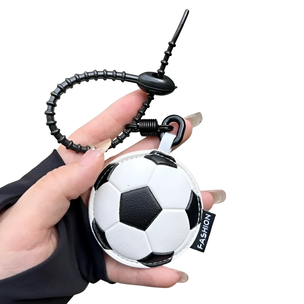 Leather sports ball keychain set bag charm featuring a black and white textured leather soccer ball with coiled strap and spring mechanism