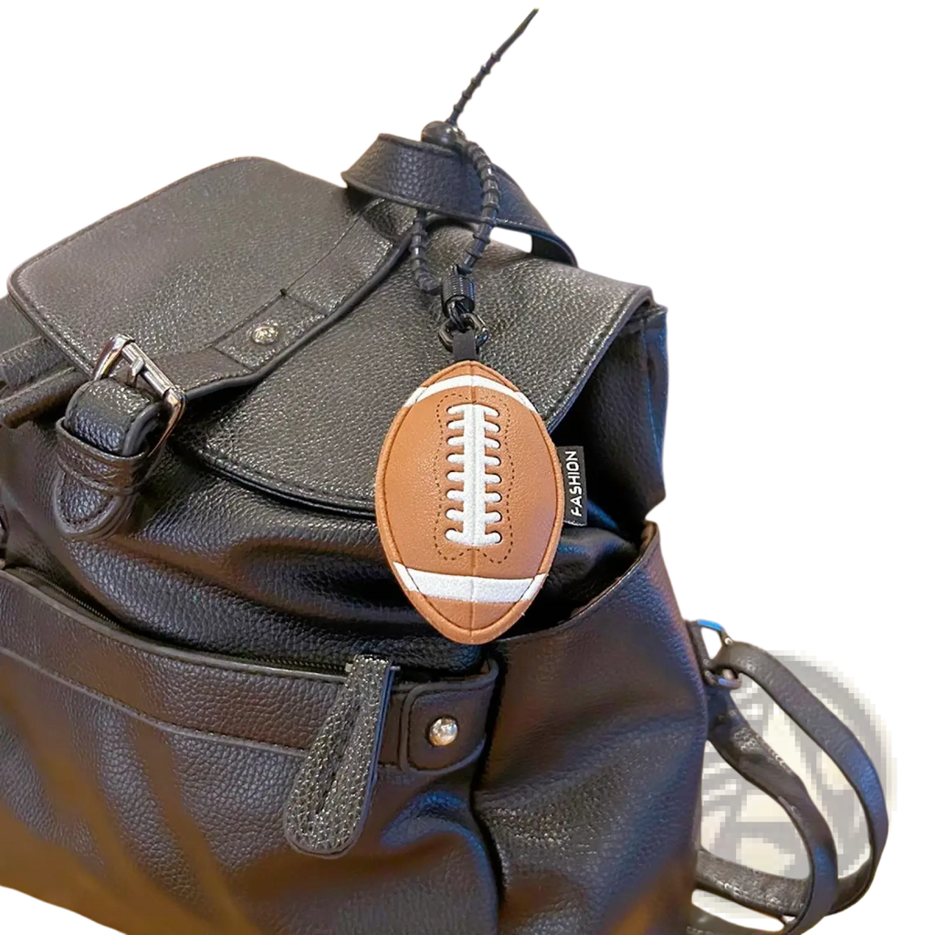 Brown leather football-shaped keychain with white laces and stitching details for sports ball set bag charm