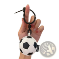 Black and white leather sports ball keychain with a textured surface used as a bag charm accessory