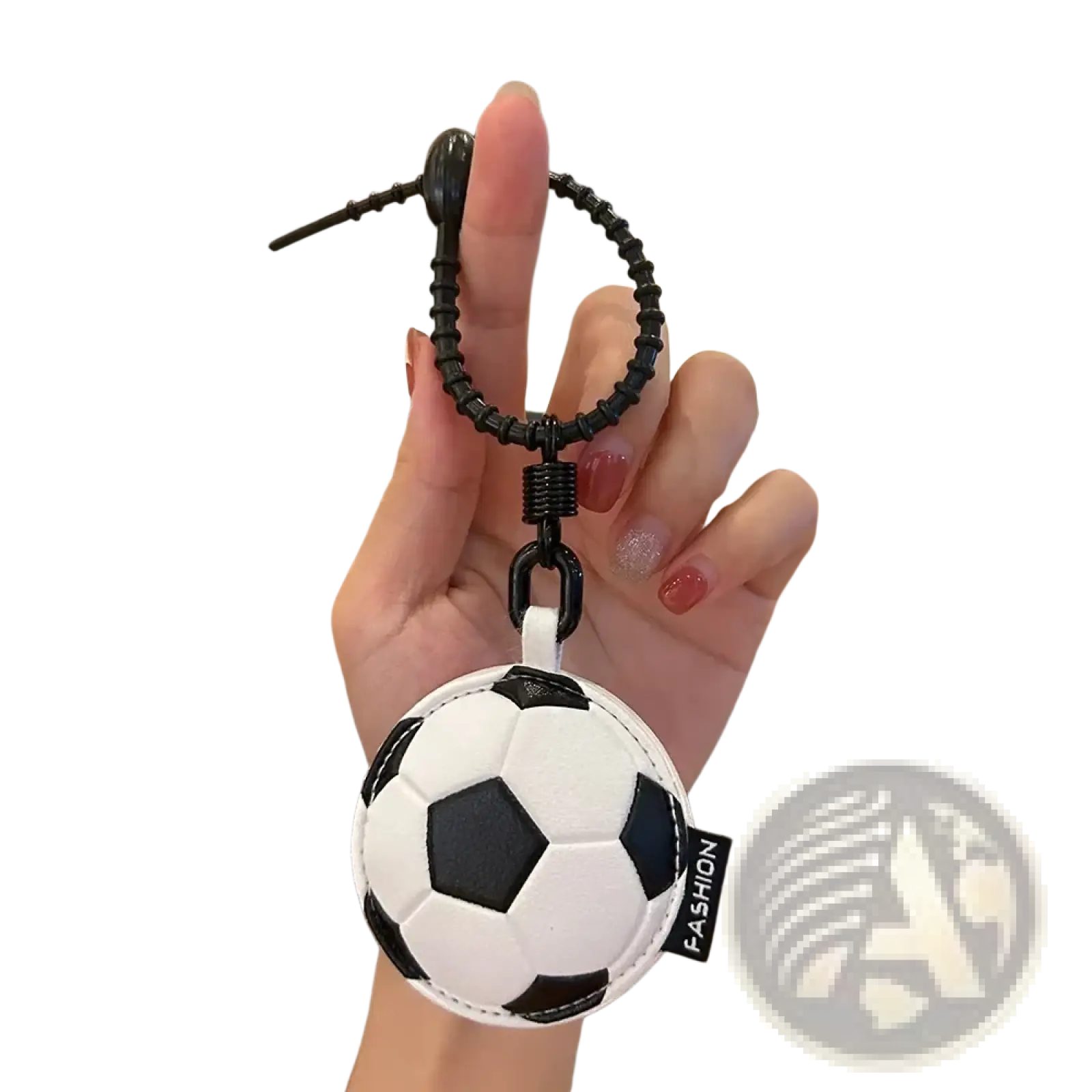 Black and white leather sports ball keychain with a textured surface used as a bag charm accessory