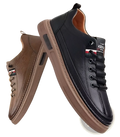 Leather sports sneakers cushioned fashion shoes in black and brown leather with textured upper and tan rubber soles