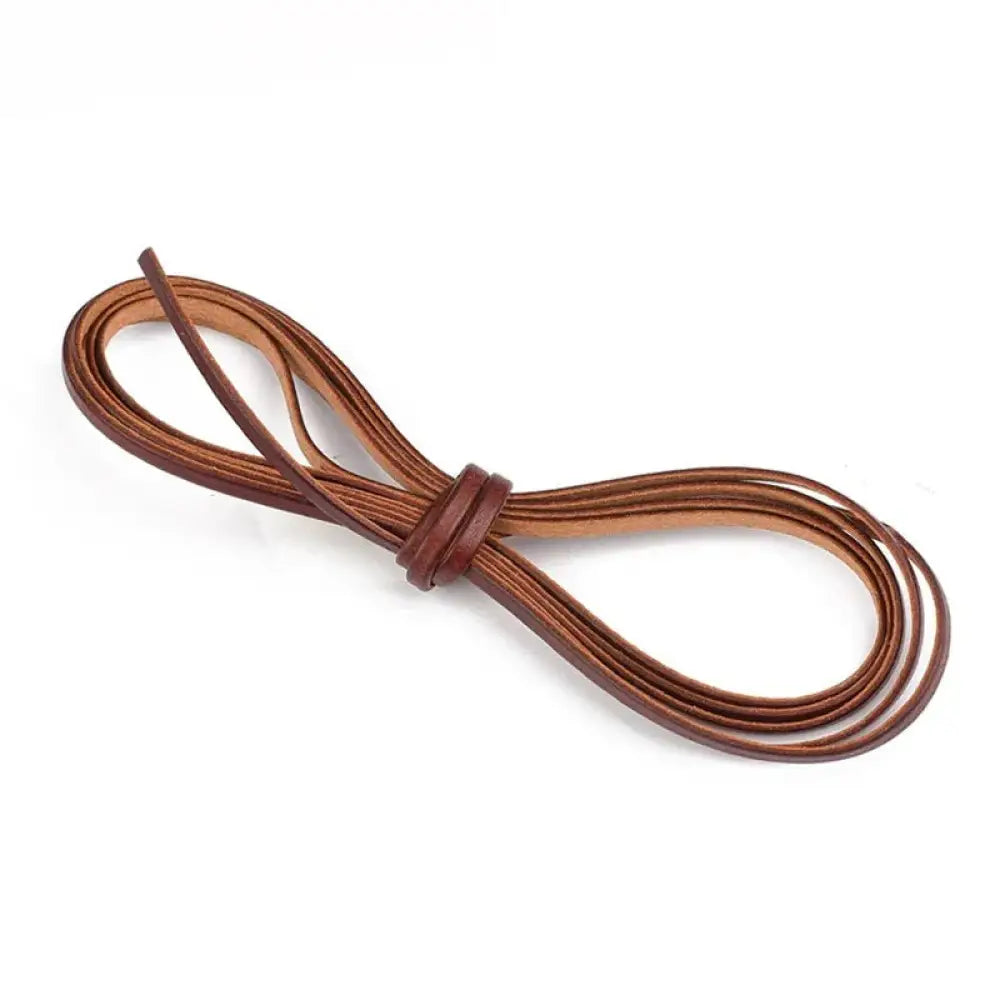 Handmade genuine leather cord in brown, neatly coiled and tied with a simple knot for DIY crafting projects