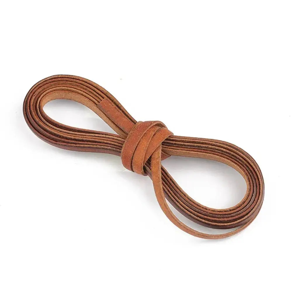 Handmade genuine leather cord in tan coiled neatly for DIY crafting projects using genuine leather material