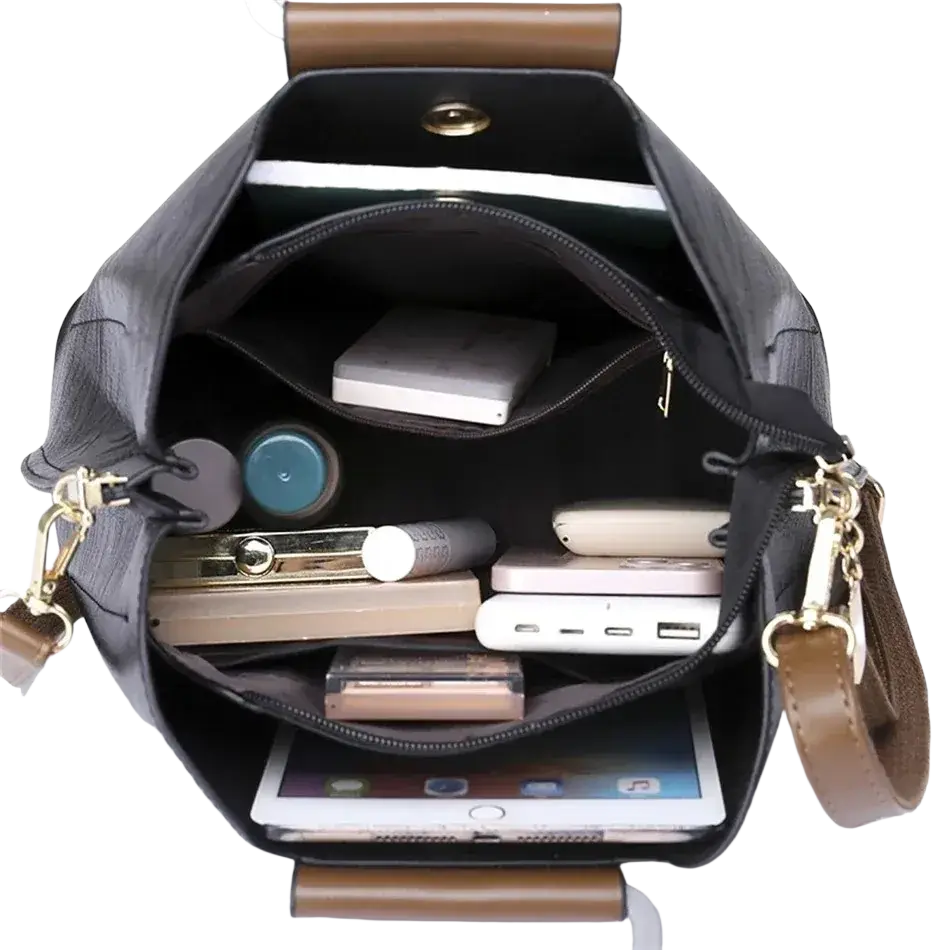 Black leather tote bag with brown handles and gold-tone hardware featuring a pocket interior for organized storage