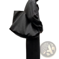 Black leather tote bag with large capacity designed for commuter and shopper use