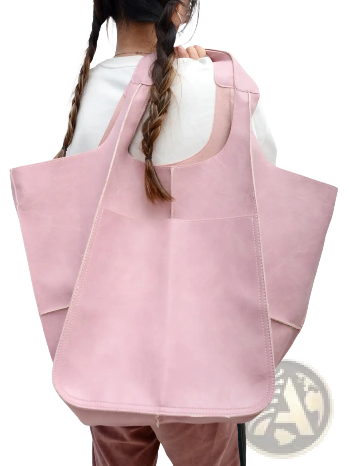 A soft pink leather tote bag with large capacity, structured design, minimalist style, and visible stitching
