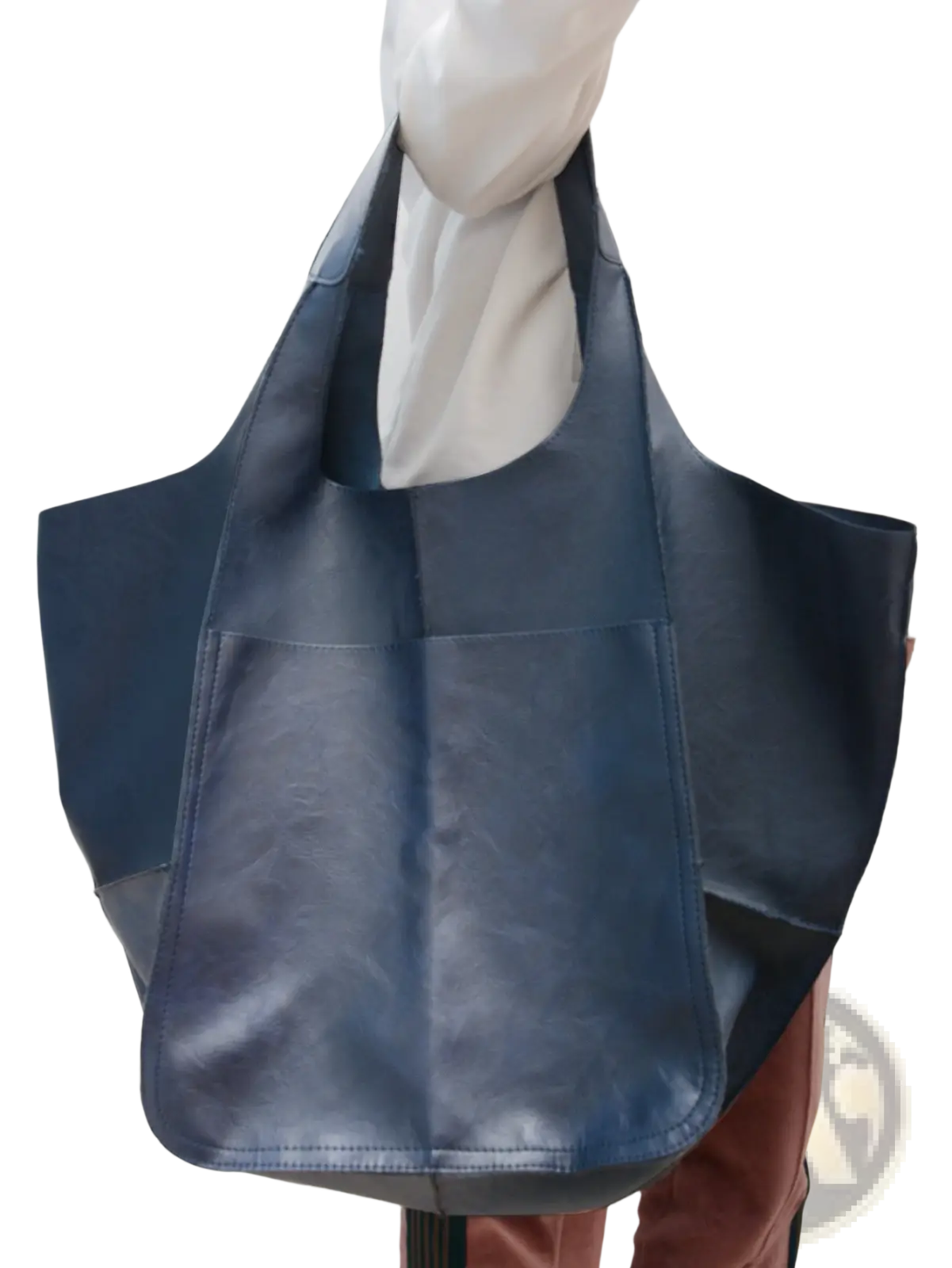 A navy blue leather tote bag with a large capacity, soft slouchy design, and visible stitching details