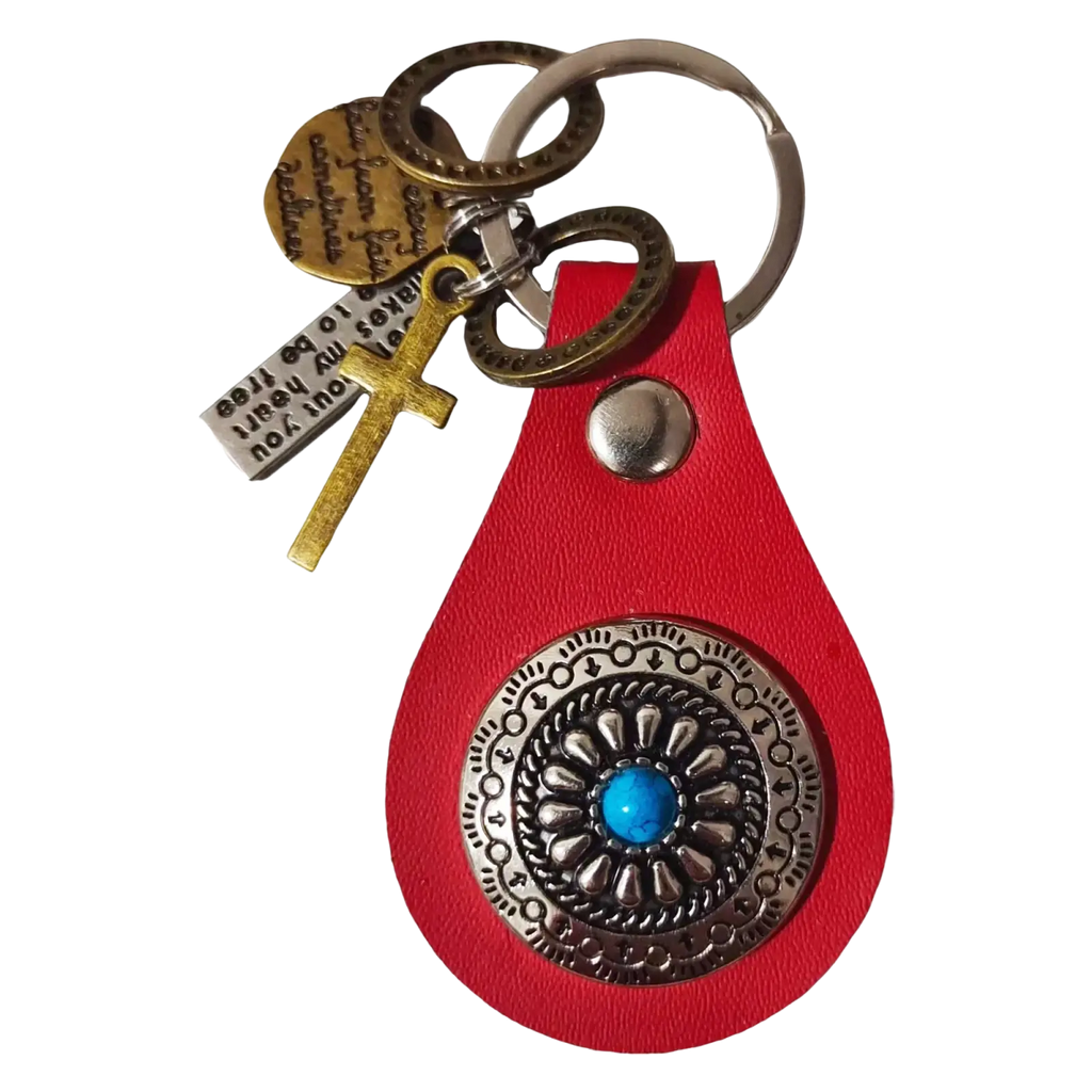 Red leather keychain charm with silver ornate medallion featuring turquoise stone and multiple engraved tags