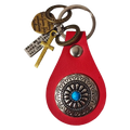 Red leather keychain charm with silver ornate medallion featuring turquoise stone and multiple engraved tags