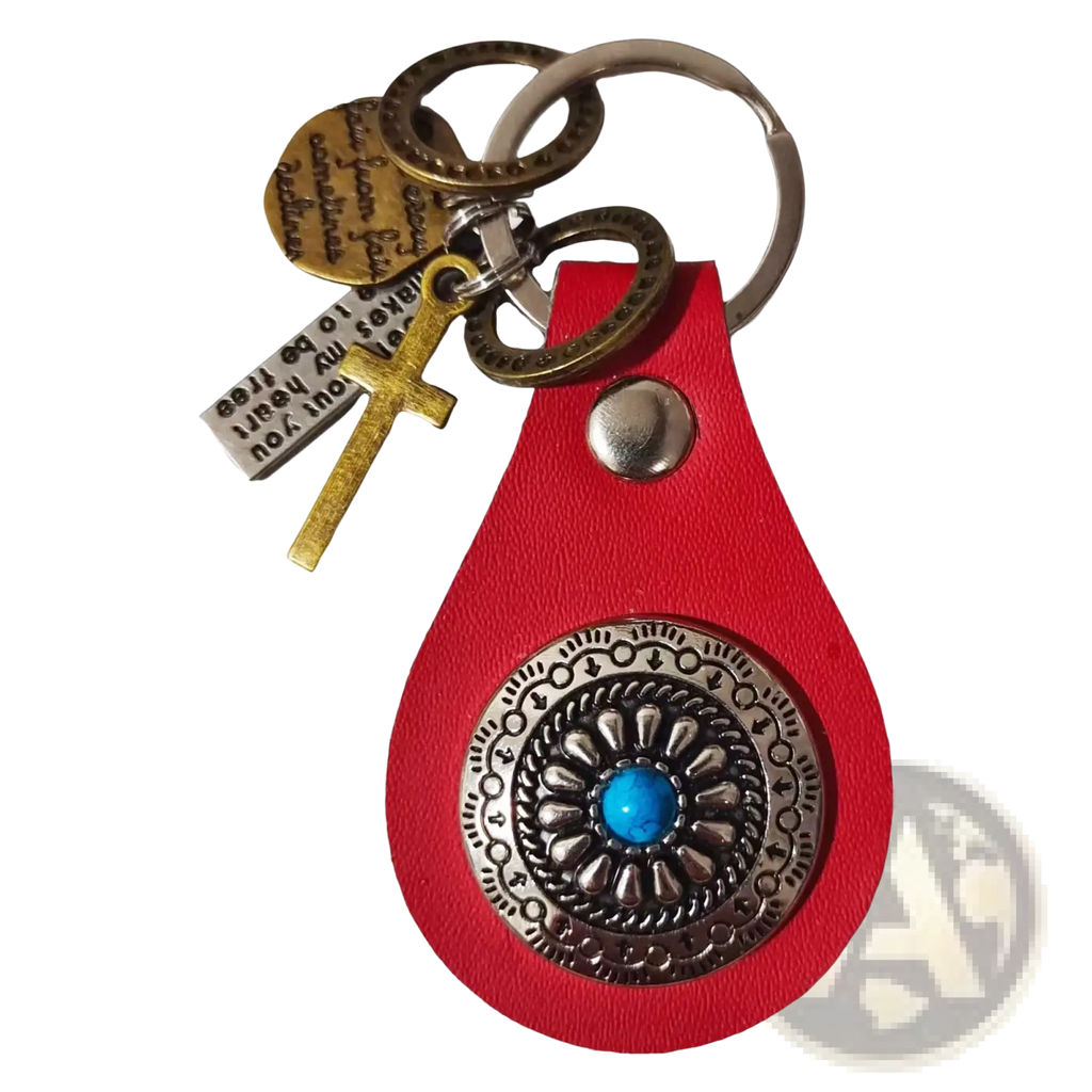 Red leather keychain charm with silver ornate medallion featuring turquoise stone and multiple engraved tags