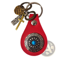 Red leather keychain charm with silver ornate medallion featuring turquoise stone and multiple engraved tags