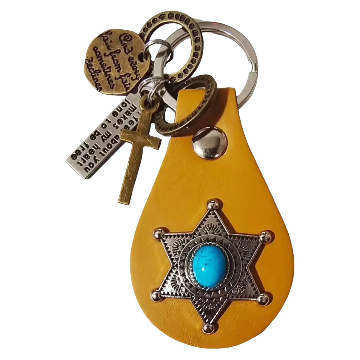 Yellow leather keychain featuring a turquoise stone set in an ornate silver star badge with metal charms including a cross