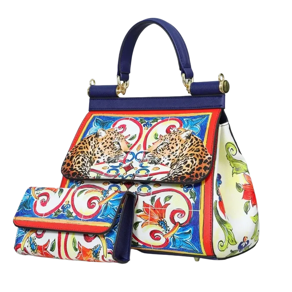 Leather vintage art shoulder bag in vibrant blue and white with intricate leopard floral patterns and gold-tone hardware