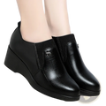 Black leather wedge ankle boots for women with ribbed elastic cuff and subtle embossed texture casual slip-on shoes