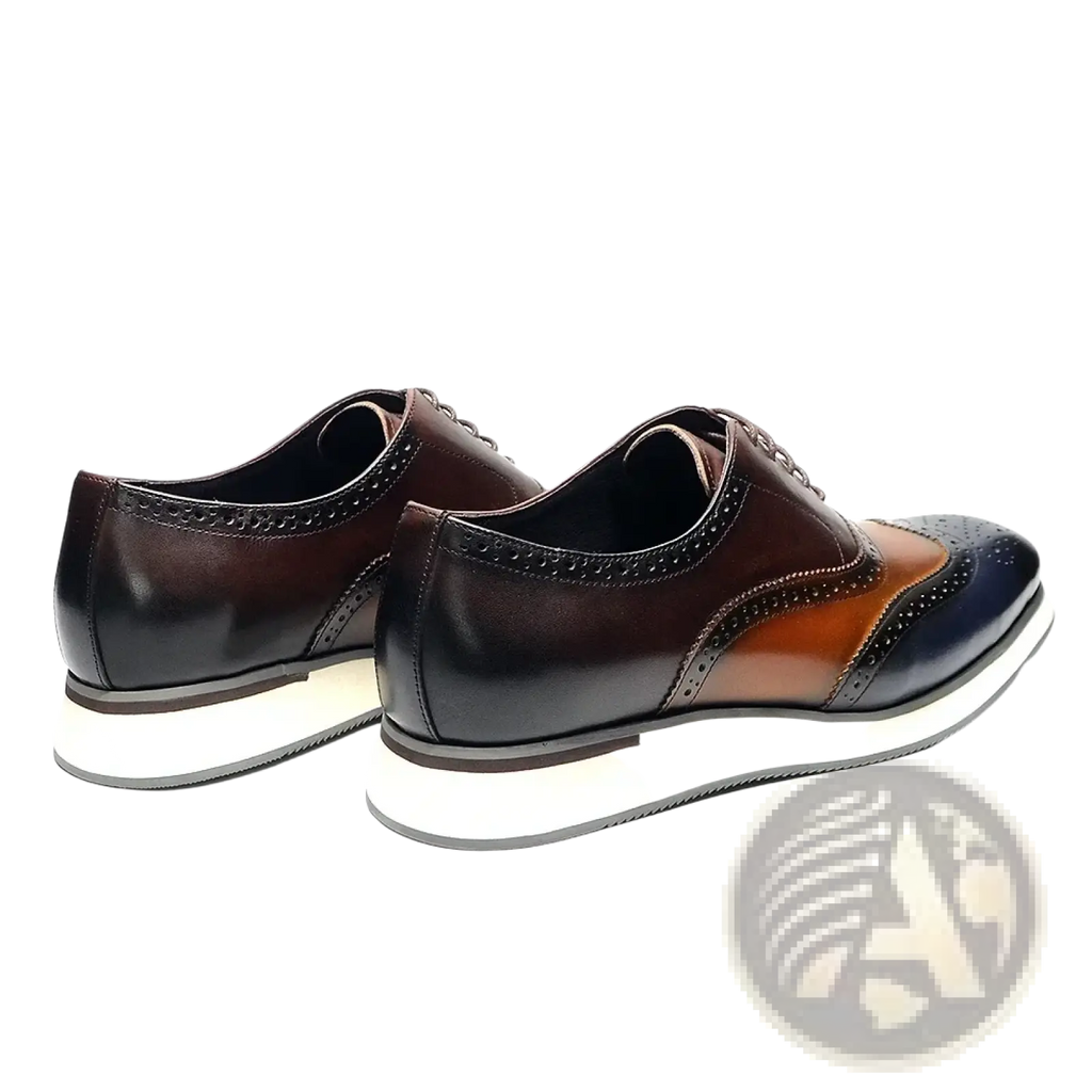 Leather wingtip brogue oxford sneakers in brown and navy blue two-tone leather with a white rubber sole