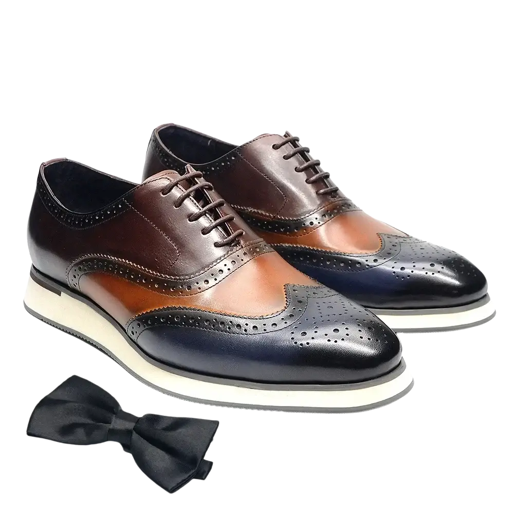 Leather wingtip brogue oxford sneakers in brown tan and black two-tone leather with a white rubber sole