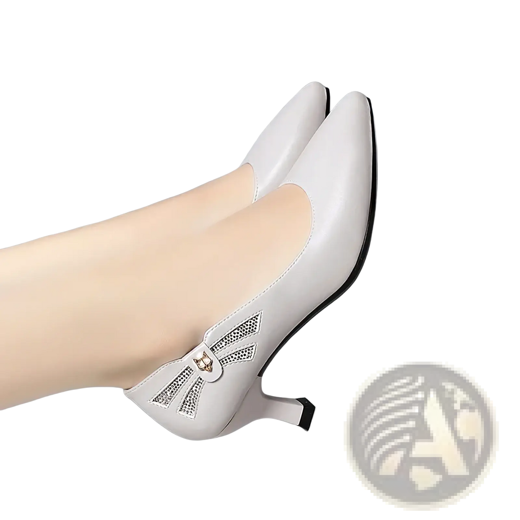 White leather mid heel work pumps featuring a cat face embellishment on the side