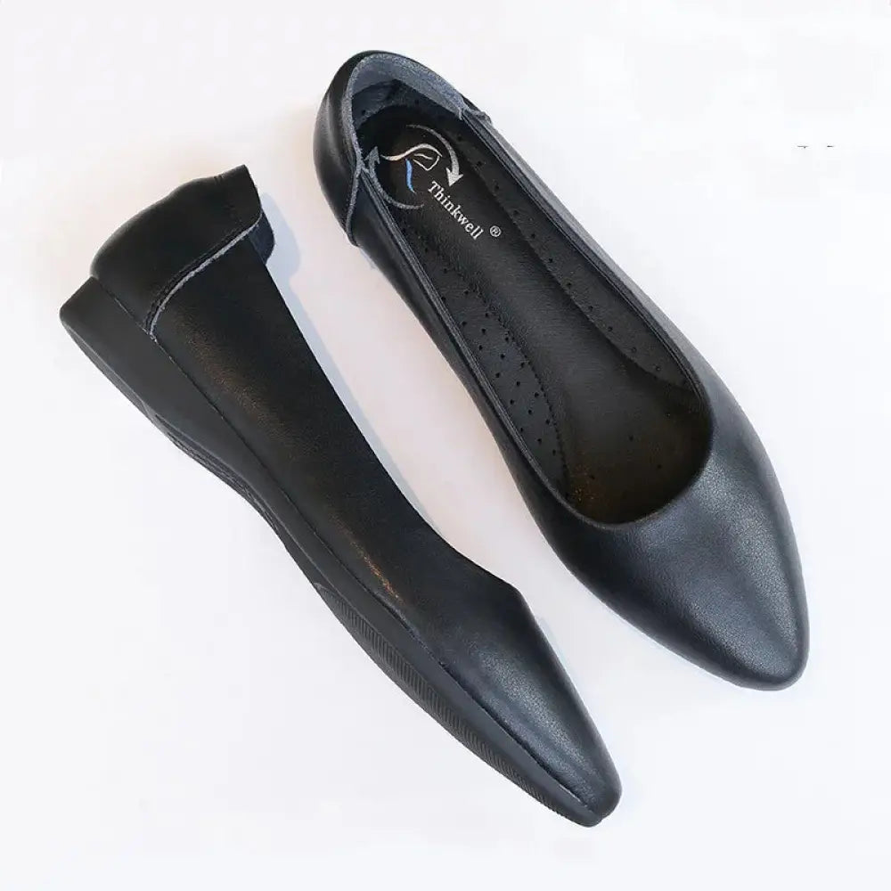 Women’s pointed toe black leather professional work flats with minimalist design and flat sole visible from the top