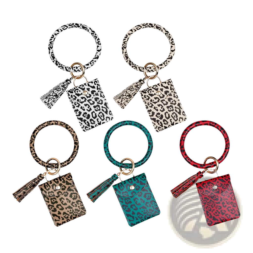 Leather wristlet keychain card holder in leopard print leather with circular ring pouch and coordinating tassel accents