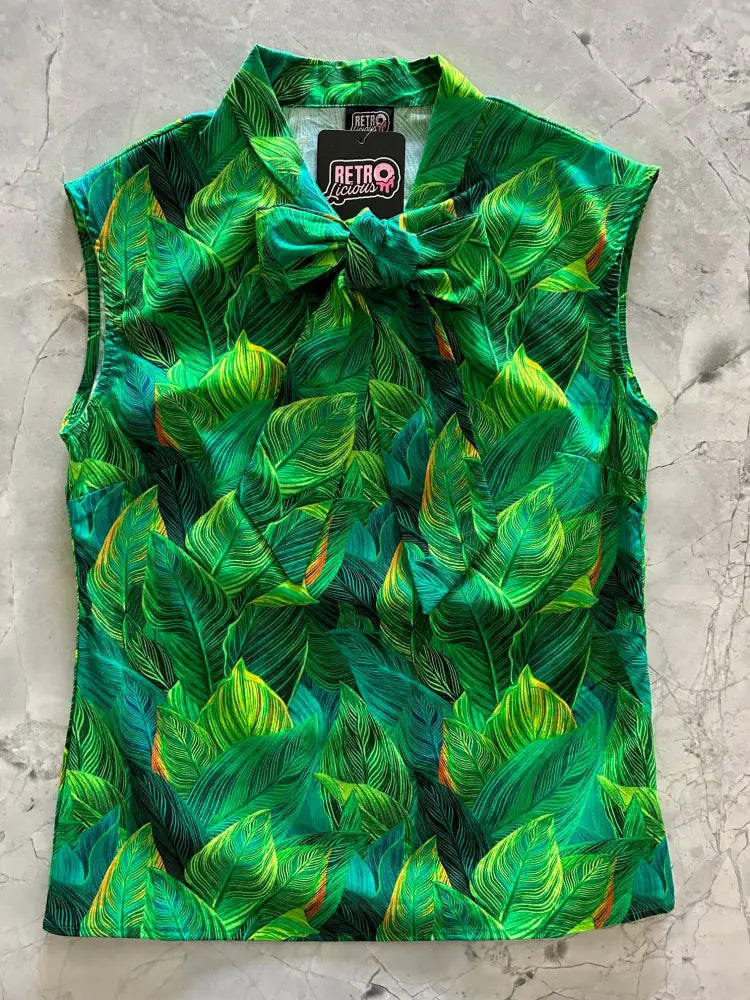 Vibrant green tropical leaf print sleeveless cotton blouse with matching bow at collar vintage 1950s style