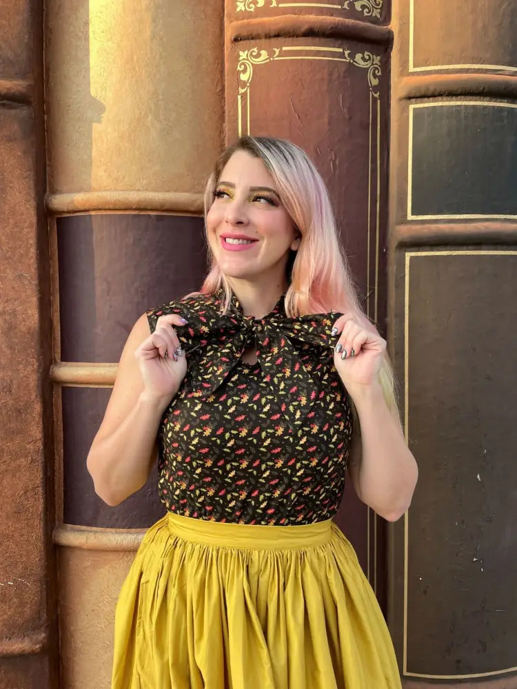A black vintage leaves print cotton blouse with floral pattern and large bow at the neckline
