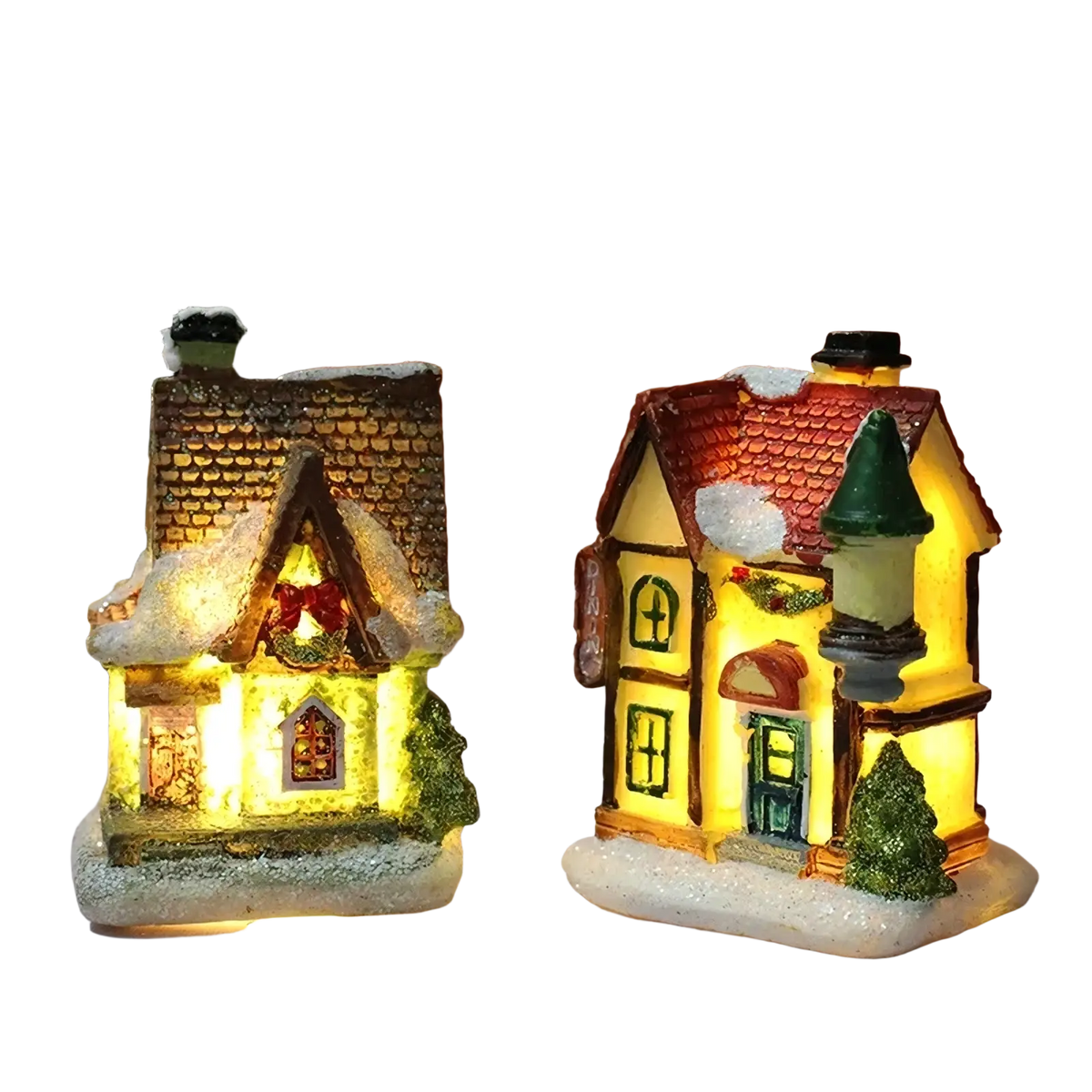 Two illuminated led christmas village houses with brown shingled and red tiled roofs featuring snow dusted details and warm light